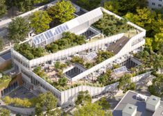 an aerial view of a building with trees on the roof