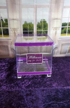 a purple velvet area rug with a glass case on it