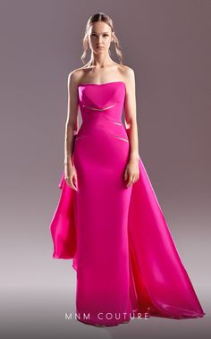 a woman in a pink dress posing for the camera with her hands on her hips