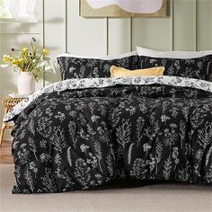 black and white bedding with flowers on it