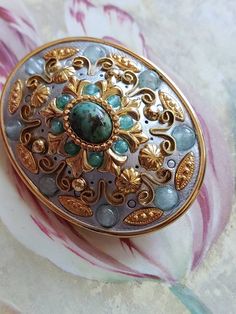 This is a vintage Micheal Golan, oval, gold tone metal, geometric pin or brooch or it can be worn as a pendant, in shades of blue. This measures just shy of 1.75 x just over 1.25 inches. Don't forget to stop in at my other Etsy shop... http://www.etsy.com/shop/xtdesigns. Follow me on Twitter at... MyYiayiaHadThat@MyYiayiaHadThat. If you have a wish list or are looking for something specific, please ask. I may have exactly what you are looking for. As always please convo me with any questions or Oval Costume Jewelry Brooch, Unique Gold Brooch With Cabochon, Handmade Oval Gold Brooches, Unique Gold Brooches With Cabochon, Blue Oval Brooch, Antique Gold Brooches With Oval Cabochon, Antique Gold Brooch With Oval Cabochon, Antique Gold Oval Cabochon Brooch, Antique Gold Oval Cabochon Brooches