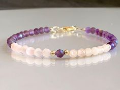 Discover the delicate beauty of our Dainty Natural Amethyst & Rose Quartz Gemstone Bracelet. This charming bracelet features approximately 4.5mm faceted-cut genuine amethyst and rose quartz gemstones, creating a subtle and elegant design. Amethyst, with its soothing purple tones, is known for its calming and spiritual properties. Rose quartz, with its gentle pink hues, is associated with love, compassion, and emotional . The combination of these gemstones creates a harmonious energy that promote Elegant Rose Quartz Healing Bracelets, Elegant Rose Quartz Gemstone Bracelets, Elegant Stackable Rose Quartz Jewelry, Elegant Healing Bracelet With Birthstone, Elegant Hand-strung Rose Quartz Crystal Bracelet, Elegant Rose Quartz Gemstone Bracelet, Hand-strung Pink Amethyst Bracelets, Spiritual Round Beaded Bracelets For Anniversary, Hand-strung Pink Amethyst Bracelet