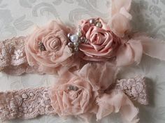 two baby headbands with pink flowers and pearls on the top one is made out of lace