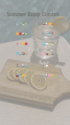 a wooden cutting board topped with slices of lemon next to a glass filled with water