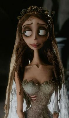 the corpse bride doll is dressed in white and has long brown hair, with eyes wide open