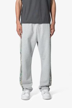 the Hunter Camo Stripe Sweatpants are designed with a relaxed fit throughout, featuring an elasticized self waist, tonal cotton drawstrings, standard hem at the leg opening, hunter camo patterned stripes at the outseam, and finished with a vintage wash. details relaxed fit 100% cotton model is 6’1, 140 lbs and wears a size medium Sporty Camouflage Cotton Bottoms, Camouflage Relaxed Fit Bottoms With Elastic Waistband, Camouflage Cotton Long Pants, Camouflage Cotton Tapered Leg Pants, Cotton Camouflage Tapered Leg Pants, Casual Camouflage Cotton Sweatpants, Camouflage Cotton Sweatpants For Streetwear, Camouflage Cotton Tapered Leg Bottoms, Camouflage Cotton Bottoms With Elastic Waistband