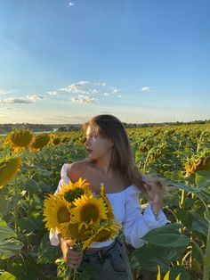 a woman standing in a field of sunflowers