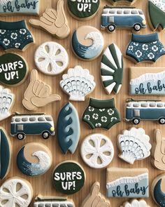 some cookies are decorated with different types of things and words on them that say surfs up, surfs up