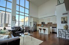 a living room filled with furniture and lots of windows