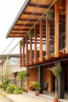 the outside of an apartment building with wooden balconies and plants on the balcony