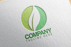 green leaf logo on white paper with the words company tagline here written below it