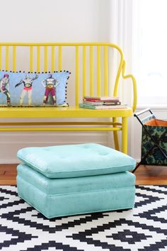 a yellow bench and ottoman in a room