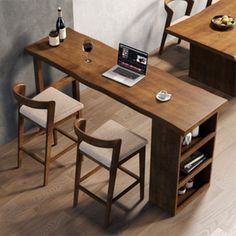 a laptop computer sitting on top of a wooden desk next to two chairs and a counter