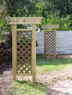 a wooden arbor in the middle of a yard