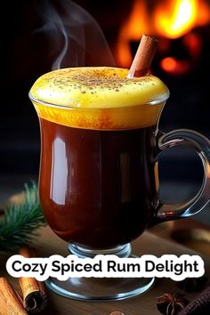 a hot drink with cinnamon sticks in it and the words cozy spiced rum delight