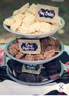 three tiered trays filled with cookies and crackers on top of each other