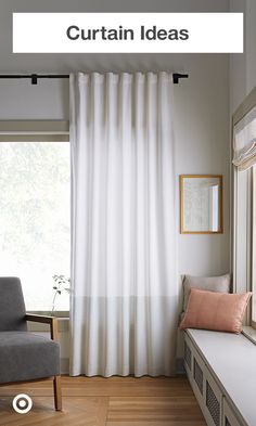 a living room with white curtains and wood floors