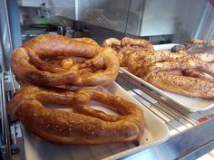 several different types of doughnuts on display in a bakery