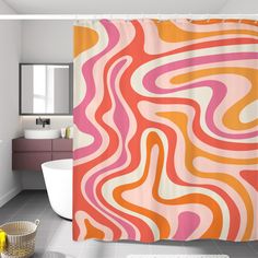 an orange and pink shower curtain in a bathroom