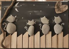 some rocks are sitting on top of a piano keyboard with mice and stars painted on them