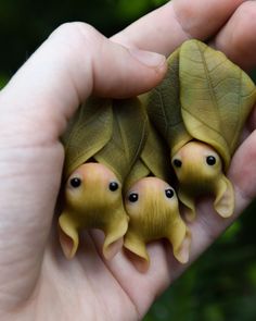 three little turtle figurines sitting in the palm of someone's hand