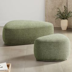 two green bean bags sitting on the floor