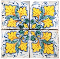 four yellow and blue tiles with designs on the bottom one is square, the other has leaves