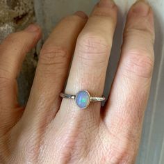 Sterling silver Ethiopian Opal ring. Oval 7 x 9mm Ethiopian opal stone. Bezel setting. 2mm round textured band. Sterling Silver Opal Ring, Silver Opal Ring, Opal Band, New Canaan, Ethiopian Opal Ring, Ring Oval, Opal Stone, Opal Ring, Moonstone Ring