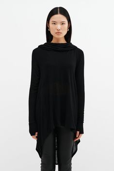 Meet our Oslo Tunic, the definition of elevated loungewear. Fashioned from soft and high-stretch sheer European jersey, she offers comfort that you can live in for days on end. Oslo updates the tunic silhouette with stunning details, such as an oversized hood and a draped, high-low hem that dips at the back. Her dropped shoulders extend to relaxed long sleeves, complete with thumbholes for a cozy, finishing touch. Shop also her best-selling sister hoodie, Firenze, crafted from our European Frenc Sleek Stretch Tops For Loungewear, Versatile Black Loungewear Tops, Athleisure Tops With Minimal Stretch For Loungewear, Versatile Fall Activewear For Relaxation, Black Top For Lounging In Fall, Black Fitted Tops For Lounging, Fitted Black Top For Lounging, Black Fitted Top For Lounging, Black High Stretch Tops For Loungewear