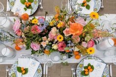 an overhead view of a table set with flowers and place settings