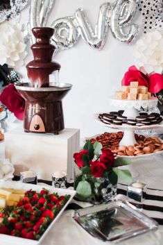 a table topped with lots of different types of food and desserts next to each other