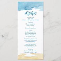 a menu card with watercolor blue and yellow colors on the front, sitting on top of a marble surface