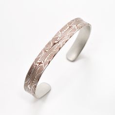 This Mokume Gane bracelet is made using techniques borrowed from pattern welded steel which involves multiple firings and complicated arrangements of layers to produce a unique and intricate pattern. Shown here in a 9mm wide bracelet with the copper and silver metal combination and an etched finish. This bracelet is a side medium and is currently in stock. All mokume pieces are available in any size, width, profile, pattern, metal combination and finish. All pieces are made individually from sta Welded Bracelet, Bracelet In Silver, Mokume Gane, Organic Pattern, Wide Bracelet, Small Rings, Damascus Steel, Damascus, Precious Metals