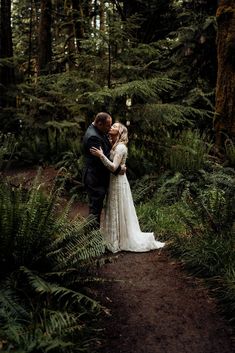 a bride and groom standing in the woods together for their wedding photo shoot by vancouver wedding photographer