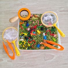 a bowl filled with lots of toys and magnifying glass on top of it