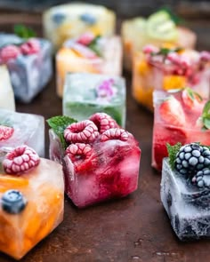 several different types of ice cubes with berries on them