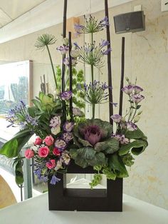 an arrangement of flowers in a vase on a table