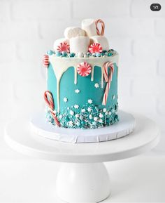 a cake decorated with candy canes and marshmallows