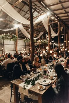 a group of people sitting around a wooden table