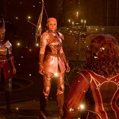 two women in armor standing next to each other with candles on the floor behind them