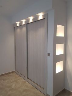 an empty room with sliding doors and lights