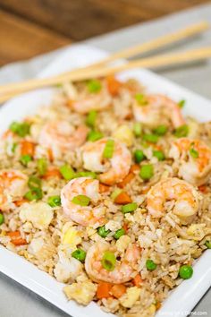 shrimp and rice on a plate with chopsticks