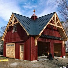 a large red barn with a black roof