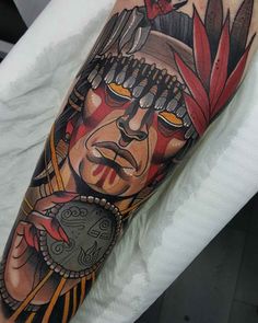 a man's arm with a native american tattoo design on the left side of his body