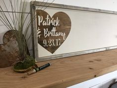 a wooden sign that says patrick and briahan 9 31 11 on the mantle