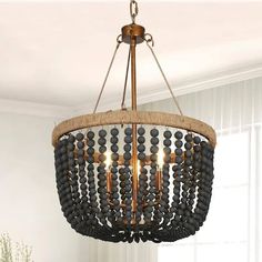 a chandelier with beads hanging from it's ceiling in a living room