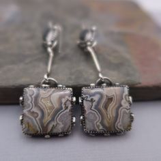 Pretty and Unique Crazy Lace Agate and Hematite set in sterling silver.  These earrings measure 3 inches long and 3/4 inches wide at the widest point.  All components are sterling silver and have been oxidized and polished.  Each earring weighs:  10.8 and 11.3 grams Thanks for shopping!! Silver Agate Drop Earrings, Silver Agate Jewelry With Matching Earrings, Silver Agate Earrings With Natural Stones, Silver Bohemian Agate Earrings, Bohemian Silver Agate Earrings, Nickel-free Silver Agate Earrings, Silver Agate Gemstone Earrings, Unique Silver Agate Earrings, Elegant Silver Agate Earrings