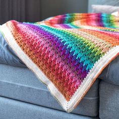 a crocheted blanket sitting on top of a couch