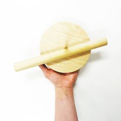 a person holding a wooden object in their hand