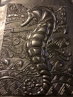 an intricately designed metal plate on display